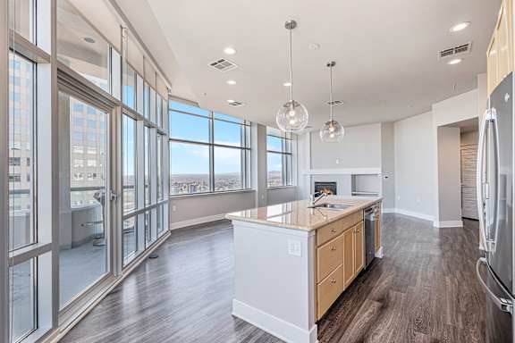 A modern kitchen with wooden floors and a large island.
