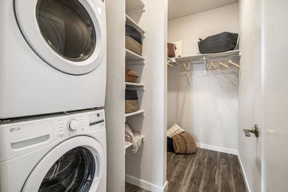 a white washer and dryer in a white laundry room
