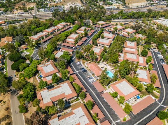 an aerial view of a neighborhood of houses and trees and a road