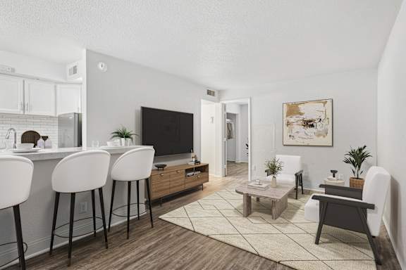 A modern living room with a bar area and a television.