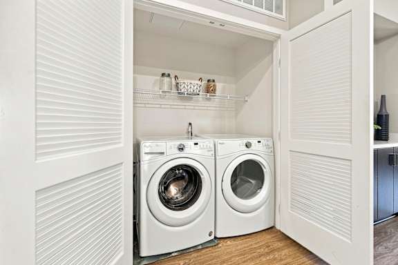 A white laundry room with a washer and dryer.