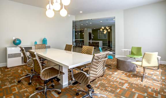 a conference room with a white table and chairs