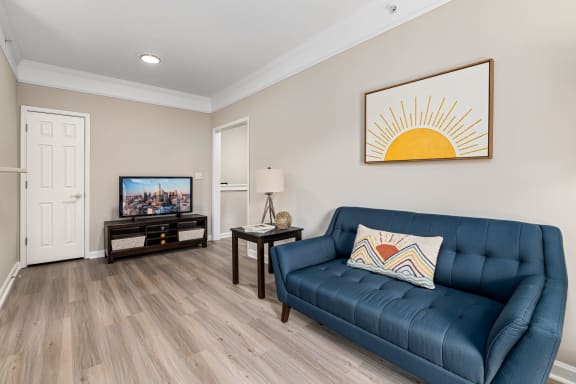 a living room with a blue couch and a tv