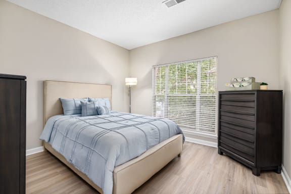 a bedroom with a bed and a dresser