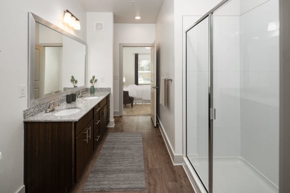 a bathroom with a shower and a sink and a mirror