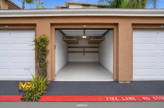 A garage with a red fire lane no stop sign on the floor.