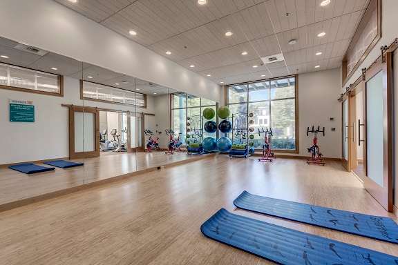 A yoga studio with mats and exercise equipment.