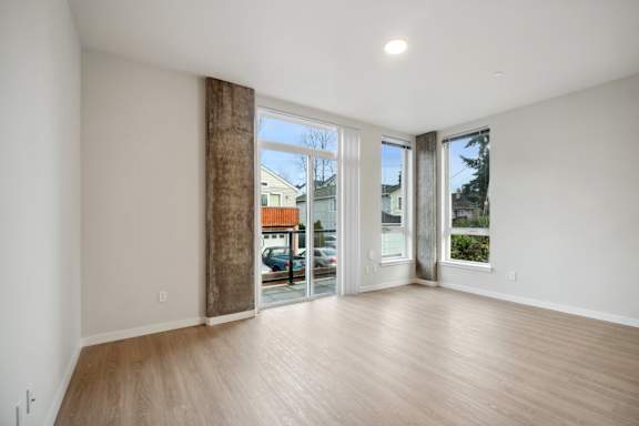 A room with a large window and sliding glass doors. at Ion Town Center, Shoreline, WA