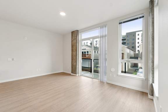 A room with a sliding glass door leading to a balcony. at Ion Town Center, Shoreline