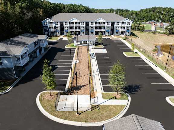 A large building with a parking lot in front of it.