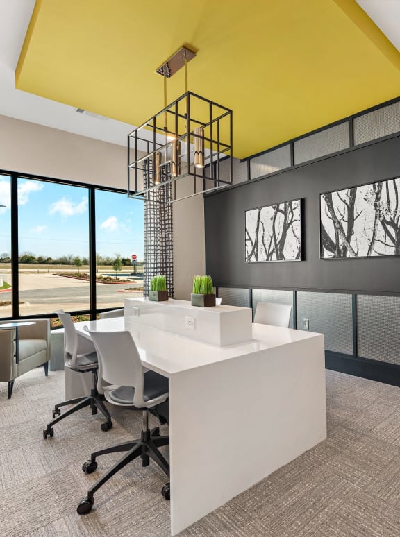 a conference room with a yellow ceiling and a table and chairs