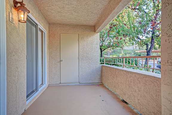 A balcony with a door and a window.