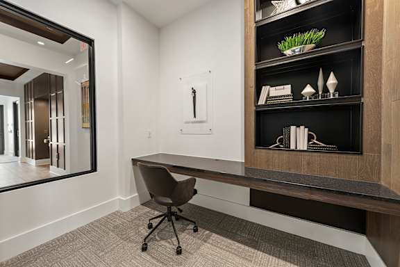A black and white room with a desk and a chair.