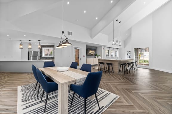 a dining room with a wooden table and blue chairs