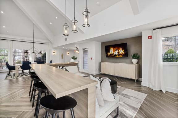 a living room with a fireplace and a table and chairs