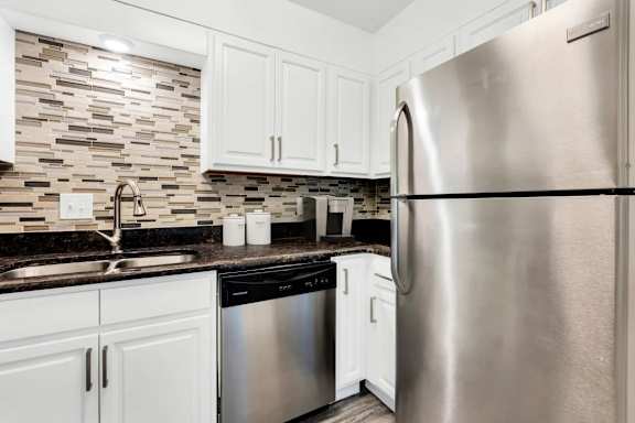 A modern kitchen with a stainless steel refrigerator.