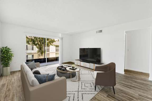 A living room with a couch, chair, and television.