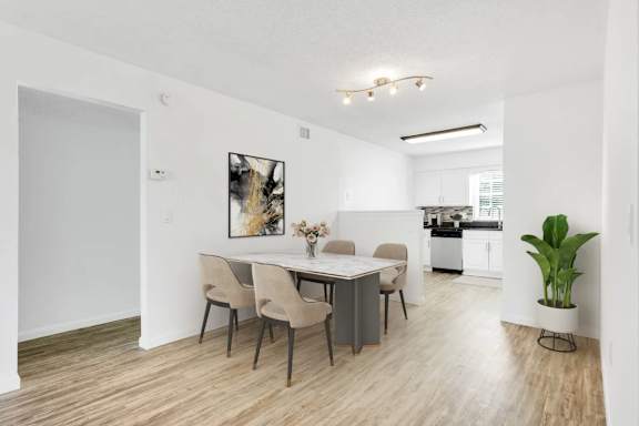 A dining room with a table and chairs.