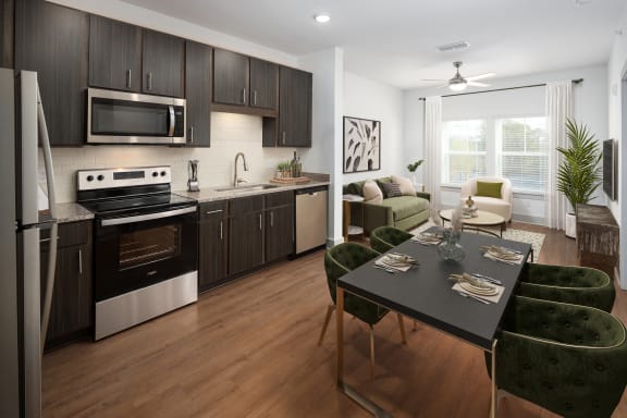 a kitchen and living room with a table and chairs