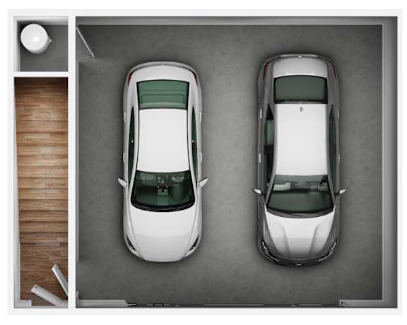 Two white cars are parked in a garage.