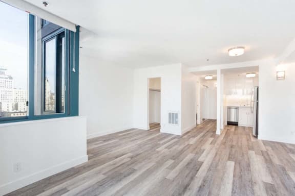 an empty living room with a large window