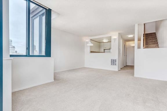 an empty living room with a large window