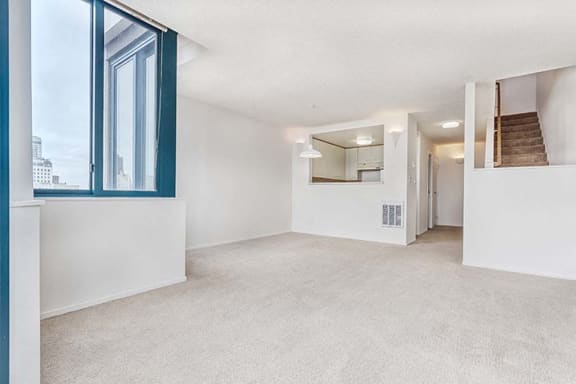 an empty living room with a large window