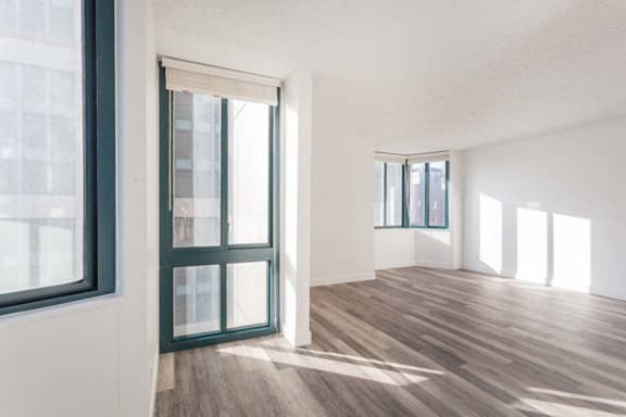 an empty room with a window and a door