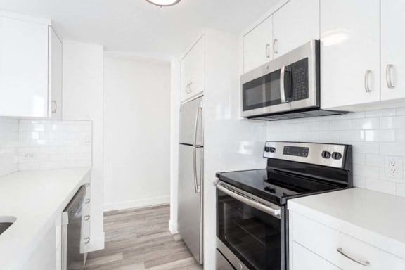 a kitchen with a stove top oven next to a refrigerator