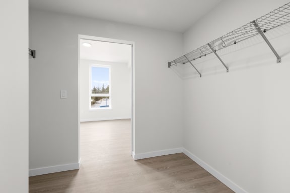 a bedroom with white walls and hardwood floors at Ion Town Center, Shoreline, WA