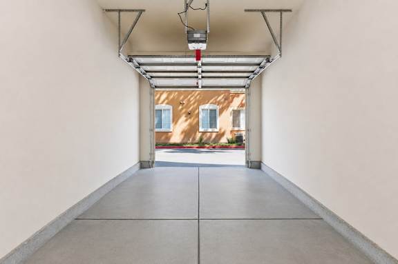 A long hallway with a red light hanging from the ceiling.