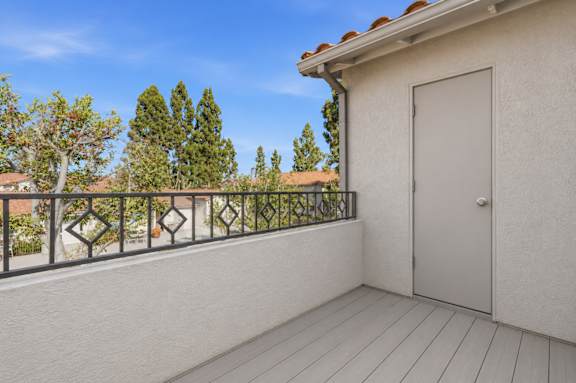 A large balcony with a storage closet.