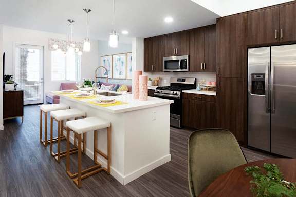 A kitchen with a white island and wooden cabinets.
