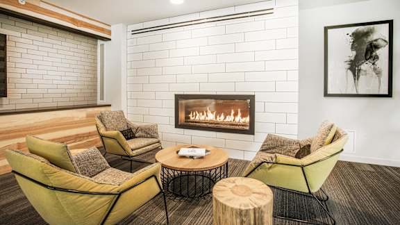 A living room with a fireplace and a painting on the wall.at Axle, Seattle Washington