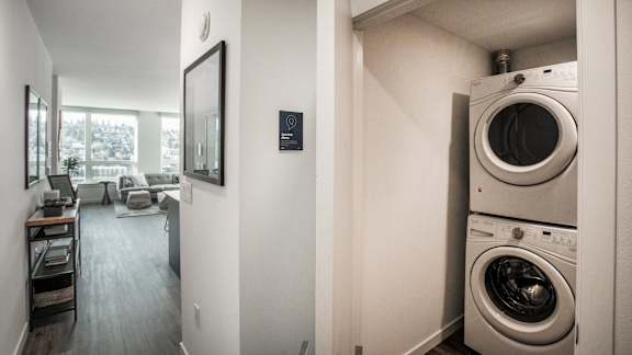 A washer and dryer stacked on top of each other in a small room.at Axle, Seattle, 98119