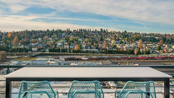 A table with four chairs overlooking a cityscape.at Axle, Seattle, WA 98119