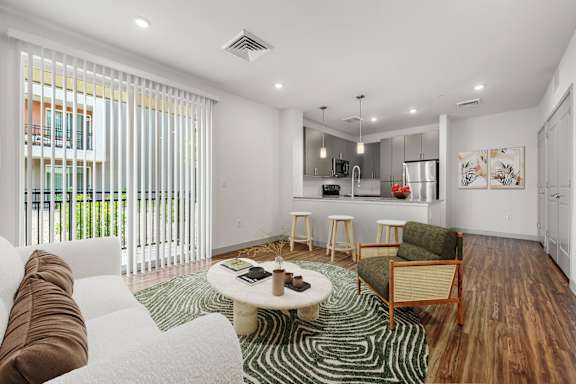A modern living room with a white couch and a coffee table.