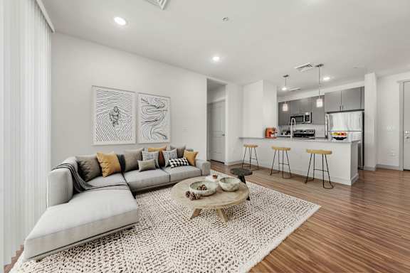 A modern living room with a grey sofa and a coffee table.