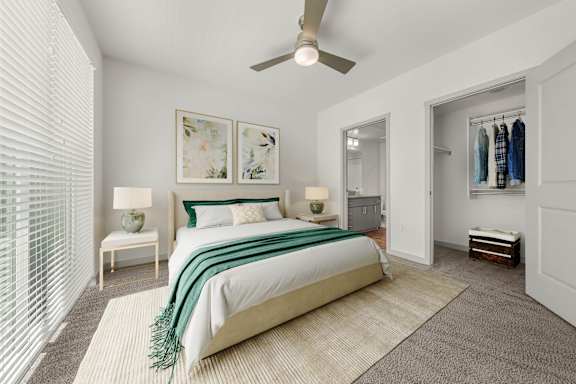 A bedroom with a large bed and a ceiling fan.