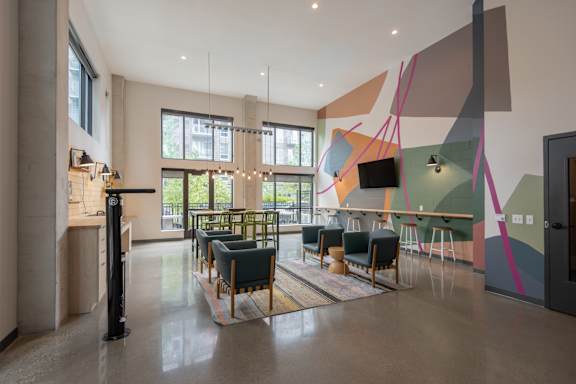 A modern room with a long table and chairs.