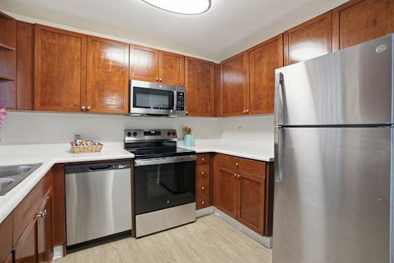 A kitchen with wooden cabinets and stainless steel appliances.