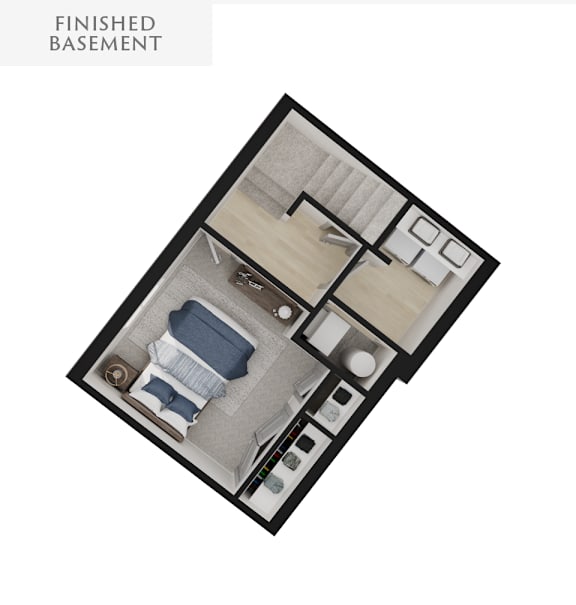 A finished basement with a bed, couch, and kitchenette.