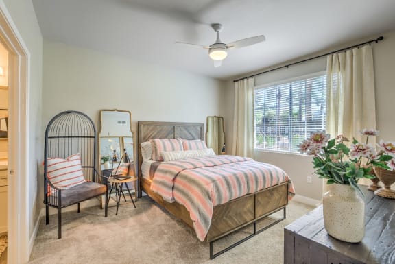 a bedroom with a bed and a ceiling fan