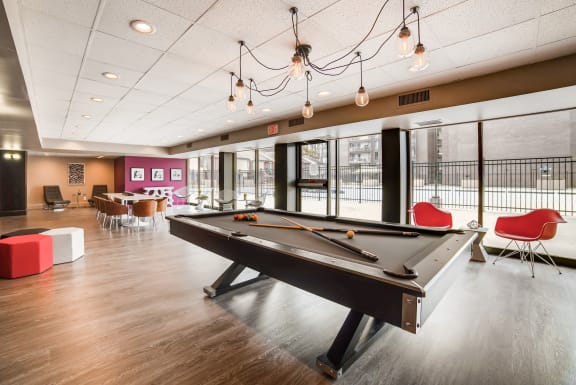 a pool table in the resident lounge at the bradley braddock road station apartments