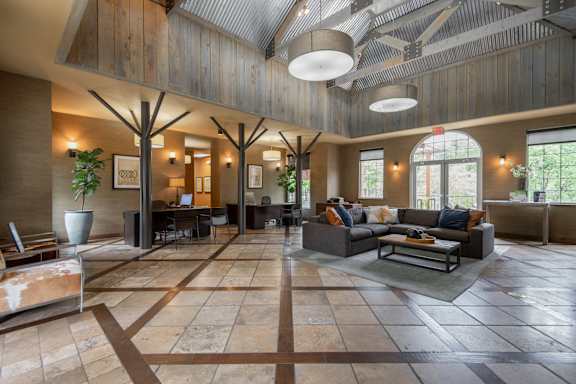A large open space with a tiled floor and wooden ceiling.