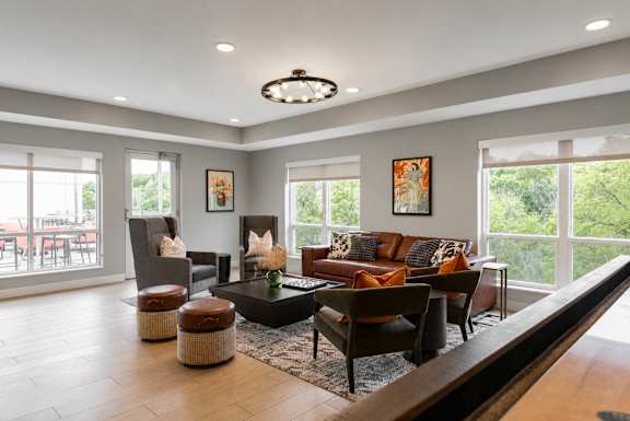 A living room with a brown couch and a coffee table.