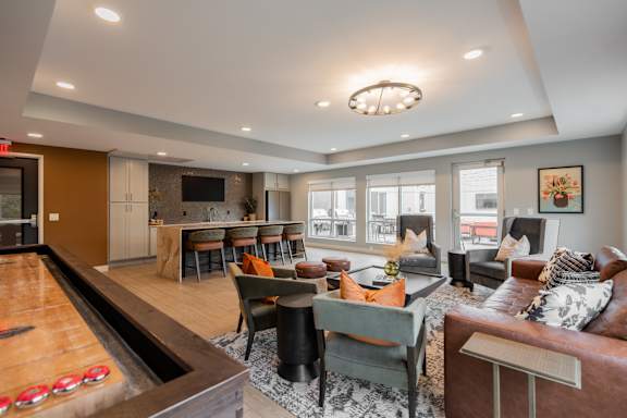A living room with a pool table and a couch.