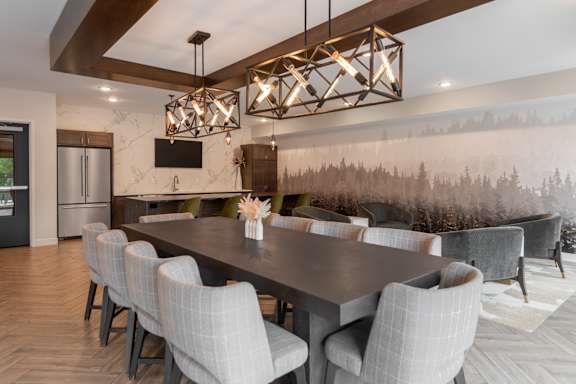 A modern dining room with a large table and chairs.