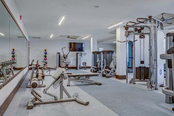 A well-equipped gym with a variety of machines and weightlifting equipment.