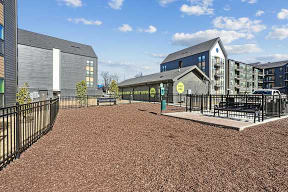 A playground area with a sign that says "BEER HOURS" is surrounded by modern buildings.